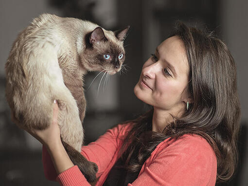 Woman holding up Cat